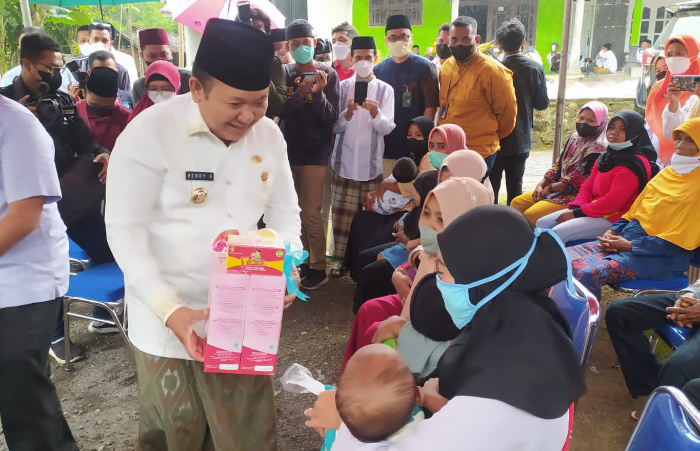 Foto: Bupati Jember Hendy Siswanto, saat membagikan bantuan susu kepada ibu menyusui di Wes Wayahe Jember Berbagi.