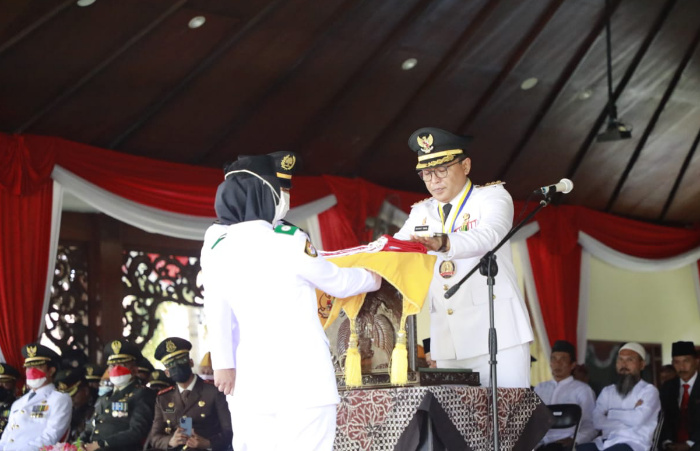 Foto: Bupati Pamekasan Baddrut Tamam saat menyerahkan Bendera merah Putih kepada Pasukan Paskibraka di mendhapa agung ronggosukowati.